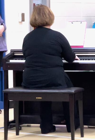 Mrs. Stebbe playing piano